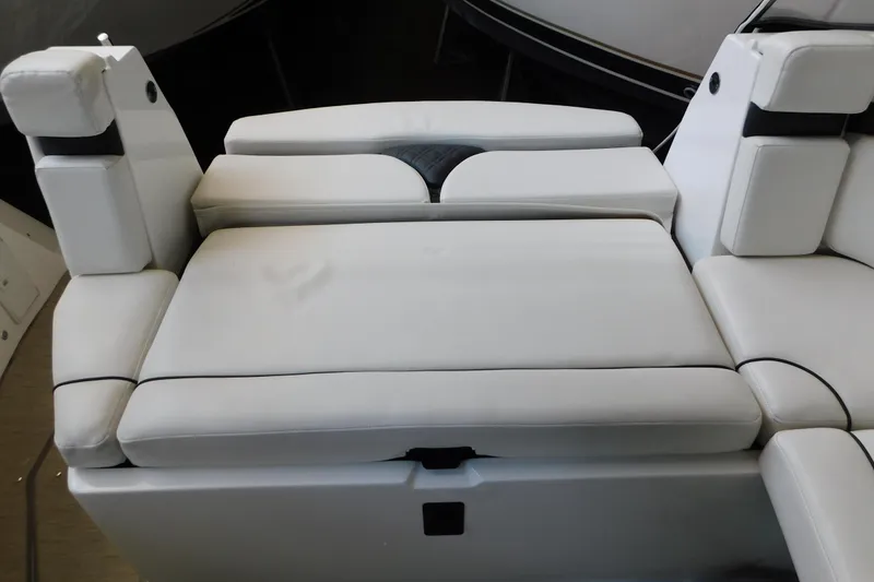 Slide: The Image of 2017 Rinker EX 320 boat interior with white cushioned seating. - 26