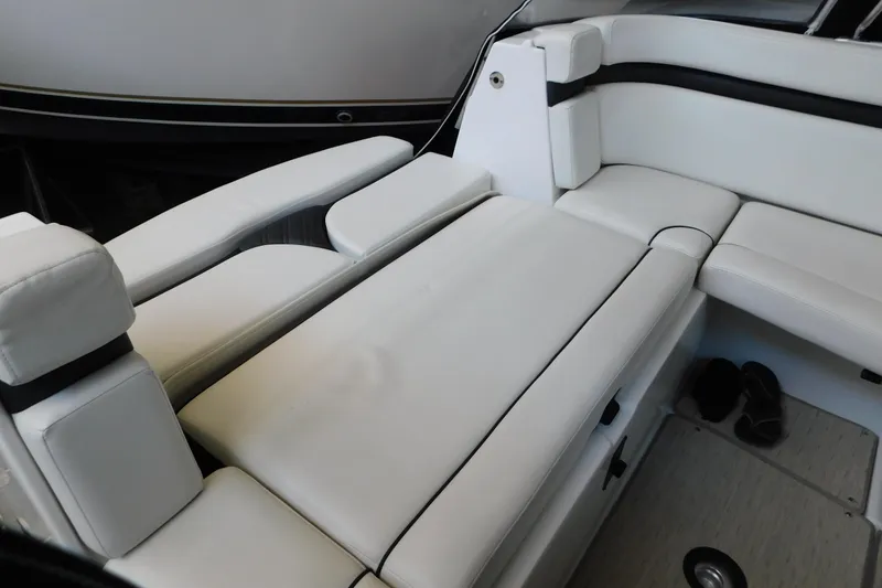 Slide: The Image of 2017 Rinker EX 320 boat interior with white cushioned seating and sleek design. - 27