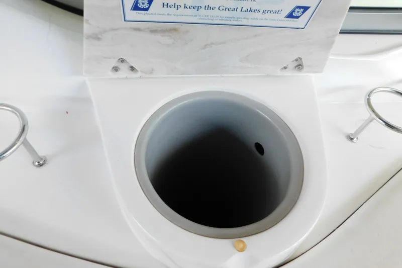 Slide: The Image of 2017 Rinker EX 320 boat cup holder with environmental message. - 30