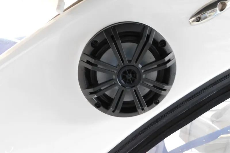 Slide: The Image of 2017 Rinker EX 320 boat speaker on white interior panel. - 31