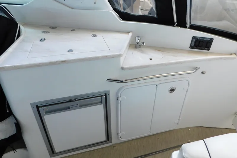 Slide: The Image of 2017 Rinker EX 320 boat interior with kitchenette, sink, and storage. - 39