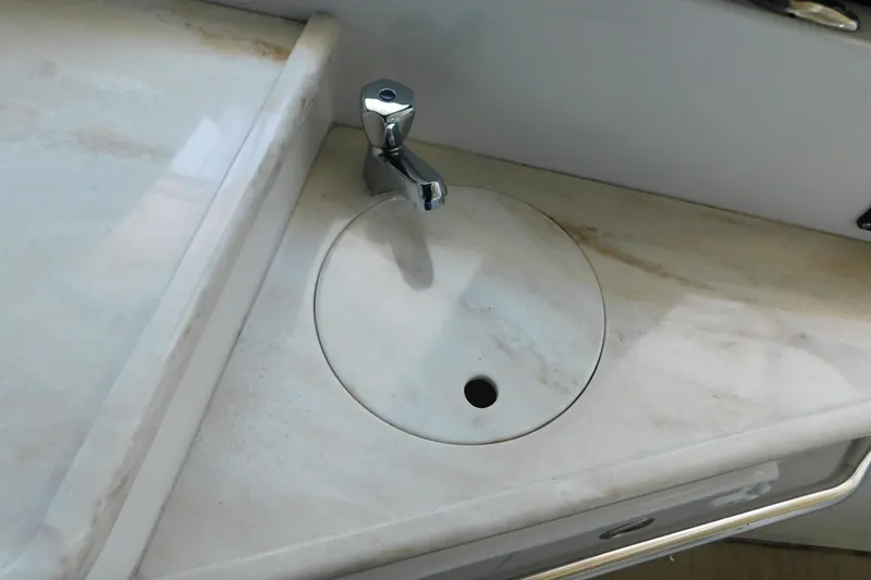 Slide: The Image of Marble sink with chrome faucet on 2017 Rinker EX 320 boat. - 40
