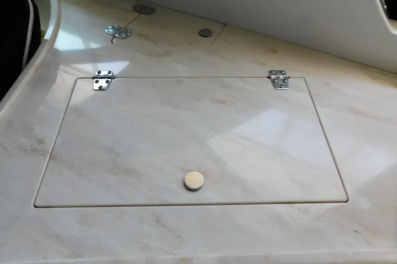 Slide: The Image of Marble countertop with hinged access panel on 2017 Rinker EX 320 boat. - 42