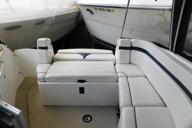 Slide: The Image of 2017 Rinker EX 320 boat interior with white cushioned seating. - 47