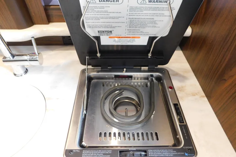 Slide: The Image of Built-in stove on 2017 Rinker EX 320 boat, featuring Kenyon electric cooktop. - 48