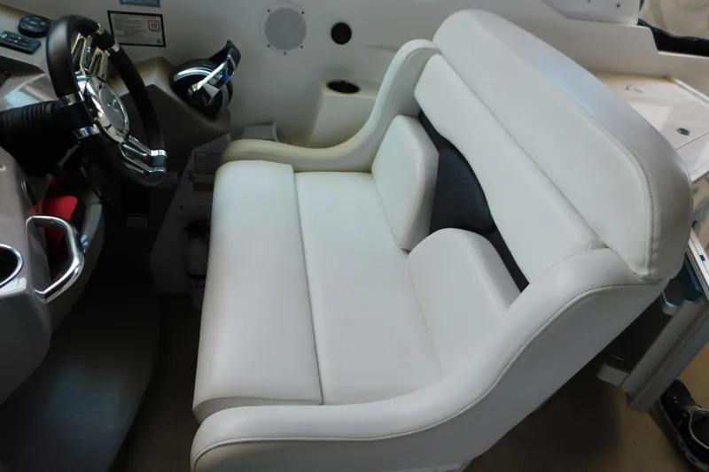 Slide: The Image of 2017 Rinker EX 320 boat interior with white leather seating and steering wheel. - 53