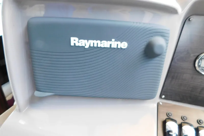 Slide: The Image of Raymarine navigation system on 2017 Rinker EX 320 boat dashboard. - 59