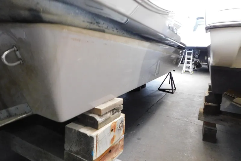 Slide: The Image of 2017 Rinker EX 320 boat hull on blocks in storage facility. - 6