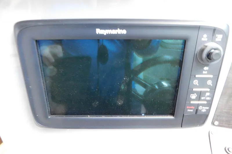 Slide: The Image of Raymarine navigation display on 2017 Rinker EX 320 boat dashboard. - 61