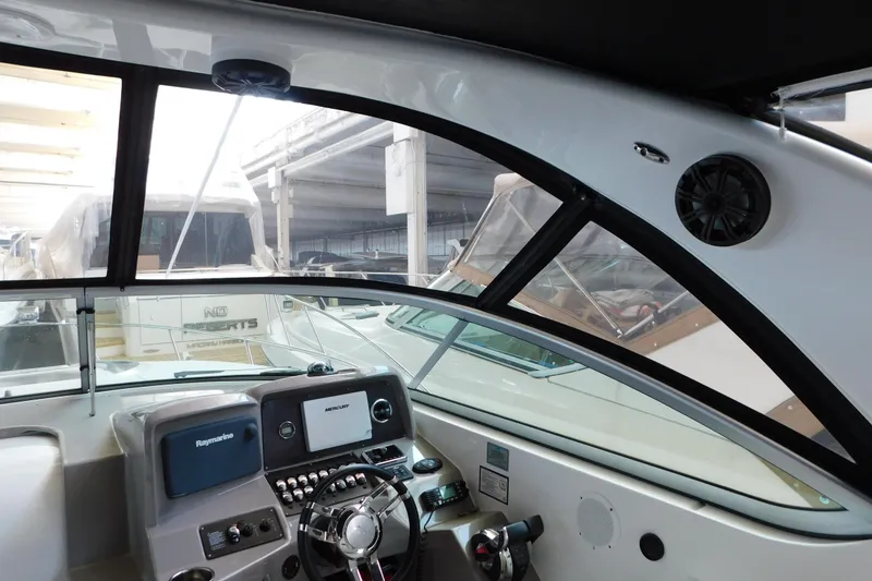 Slide: The Image of 2017 Rinker EX 320 boat cockpit with modern navigation controls and steering wheel. - 66