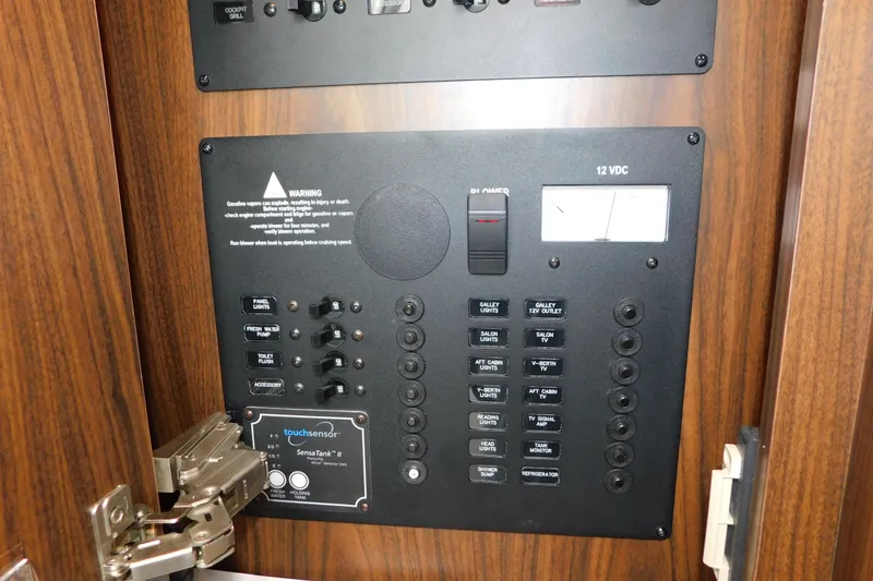 Slide: The Image of Control panel of a 2017 Rinker EX 320 boat with various switches and indicators. - 68