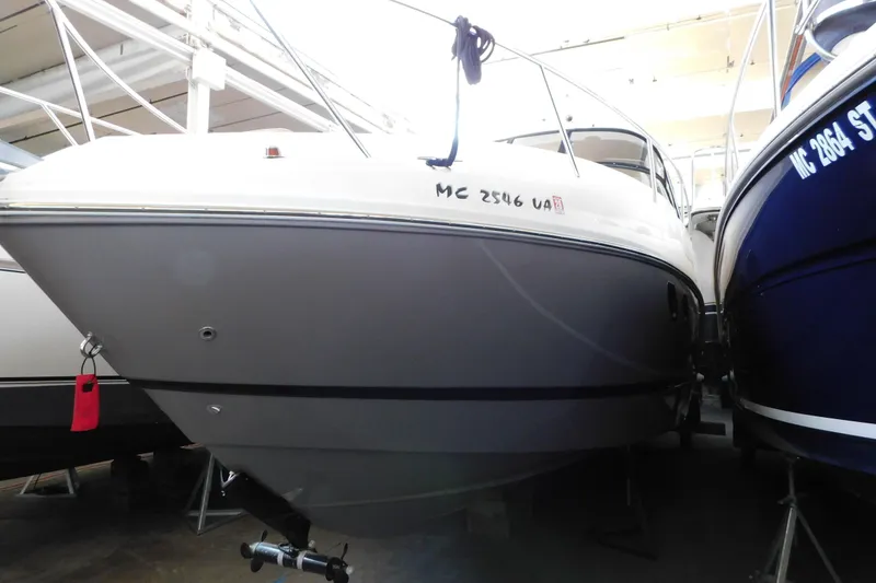Slide: The Image of 2017 Rinker EX 320 boat in storage, front view, indoors. - 7