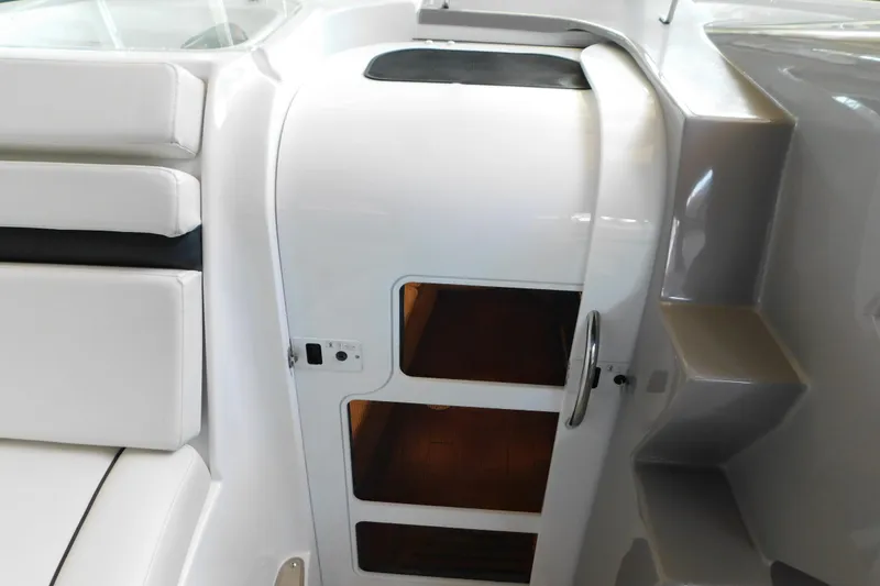 Slide: The Image of Interior cabin entrance of 2017 Rinker EX 320 boat, featuring white seating and sleek design. - 70