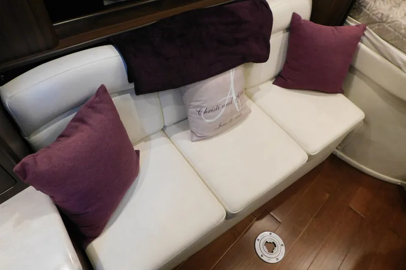 Slide: The Image of 2017 Rinker EX 320 interior with white seating and purple cushions. - 75
