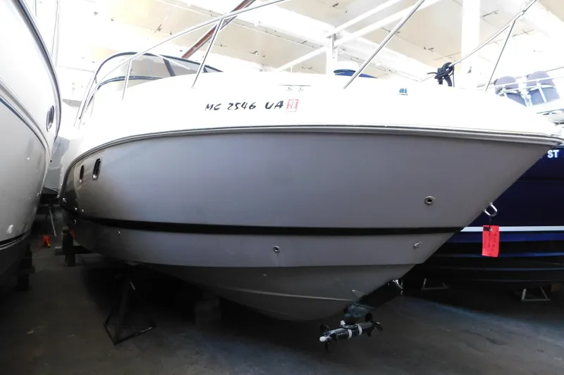 Slide: The Image of 2017 Rinker EX 320 boat in indoor storage, front view. - 8