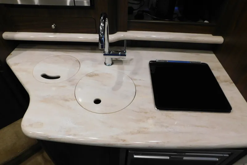 Slide: The Image of 2017 Rinker EX 320 boat kitchen with marble countertop and modern faucet. - 84