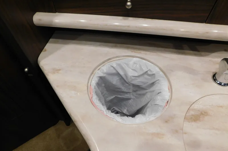 Slide: The Image of Marble countertop with built-in trash bin on 2017 Rinker EX 320 boat. - 88