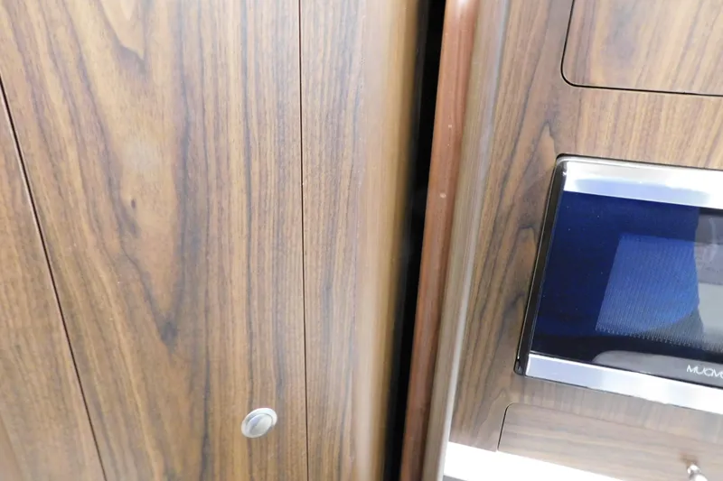 Slide: The Image of Wooden interior detail of a 2017 Rinker EX 320 boat with a built-in microwave. - 90