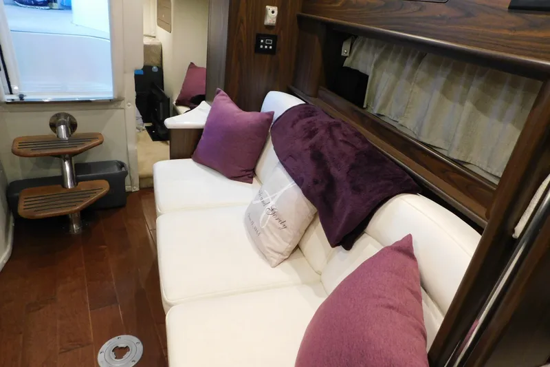 Slide: The Image of Interior of 2017 Rinker EX 320 boat with white seating and purple cushions. - 96