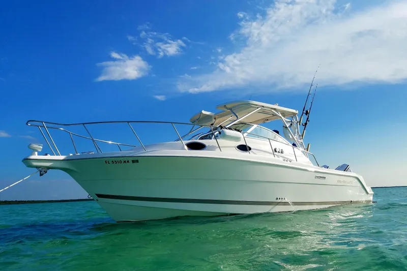 The Image of 2005 Wellcraft 290 Coastal boat on clear turquoise water under a blue sky. - 1