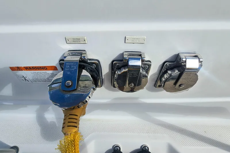 Slide: The Image of 2005 Wellcraft 290 Coastal boat power inlets with warning label and Marinco connectors. - 17
