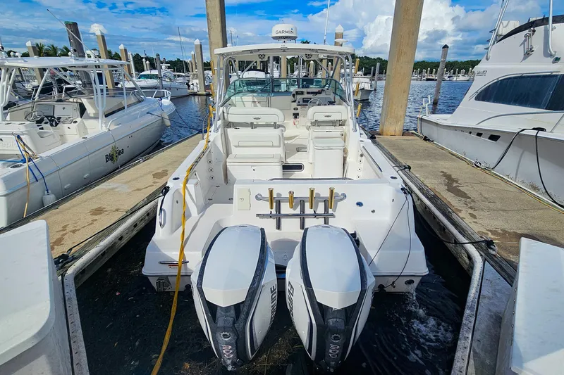 Slide: The Image of 2005 Wellcraft 290 Coastal boat docked at marina with twin outboard engines. - 19