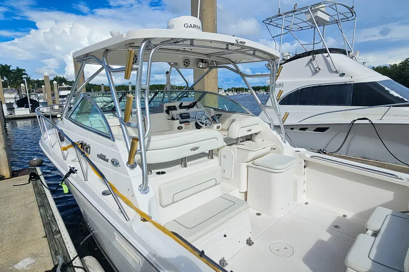 Slide: The Image of 2005 Wellcraft 290 Coastal boat docked, featuring spacious cockpit and modern equipment. - 21