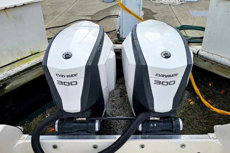 Slide: The Image of Twin Evinrude 300 engines on a 2005 Wellcraft 290 Coastal boat. - 25