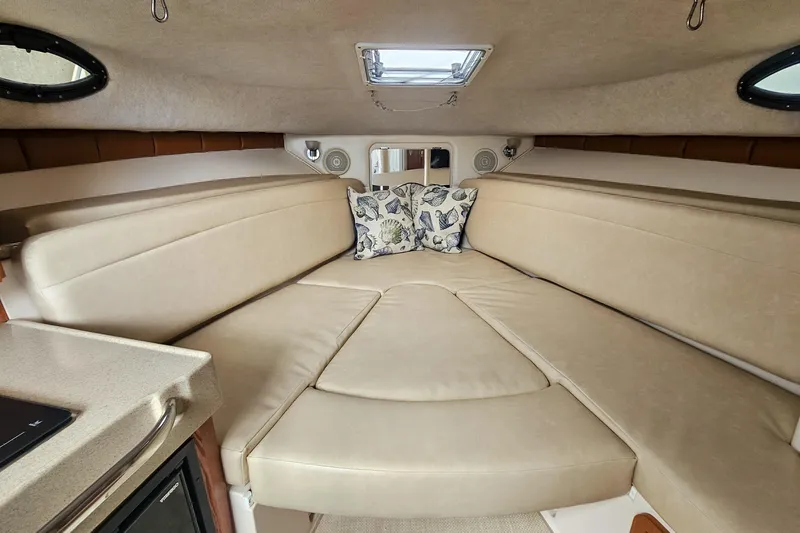 Slide: The Image of Interior cabin of 2005 Wellcraft 290 Coastal boat with beige seating and decorative pillows. - 27