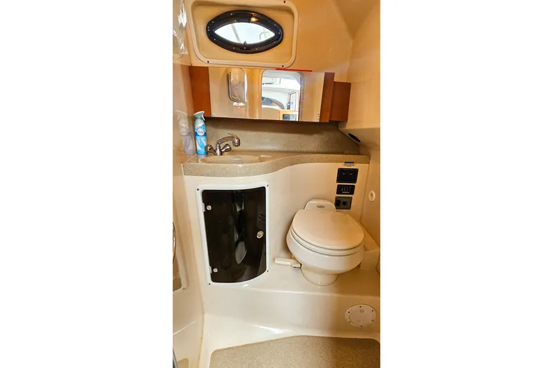 Slide: The Image of 2005 Wellcraft 290 Coastal boat bathroom with sink, toilet, and storage cabinet. - 29