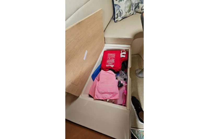 Slide: The Image of Storage compartment in 2005 Wellcraft 290 Coastal boat with life jackets and safety gear. - 33