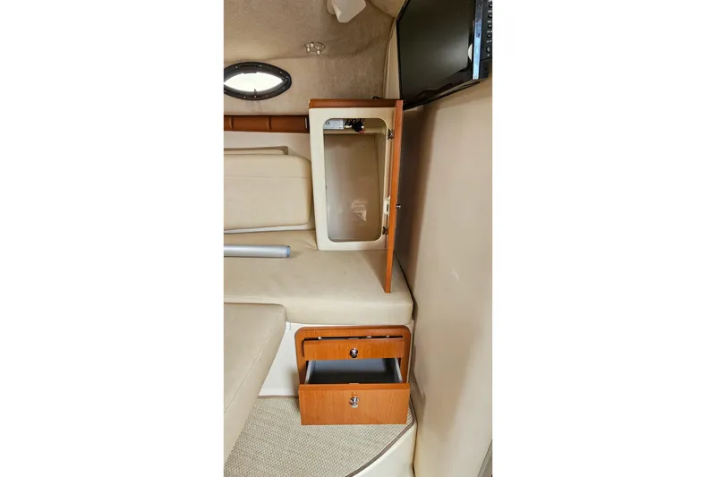 Slide: The Image of 2005 Wellcraft 290 Coastal cabin interior with open wooden storage compartments. - 34