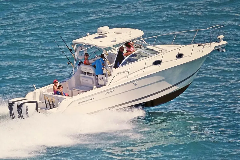 Slide: The Image of 2005 Wellcraft 290 Coastal boat cruising on open water with passengers onboard. - 4