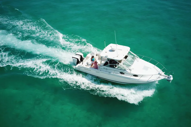 Slide: The Image of 2005 Wellcraft 290 Coastal boat cruising on clear turquoise water. - 9