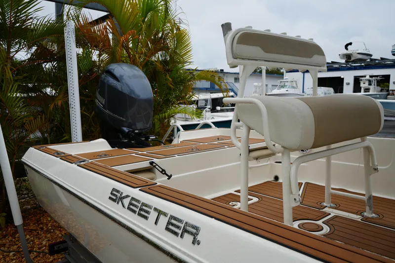 Slide: The Image of 2017 Skeeter SX230 boat with Yamaha engine, docked near tropical plants. - 12