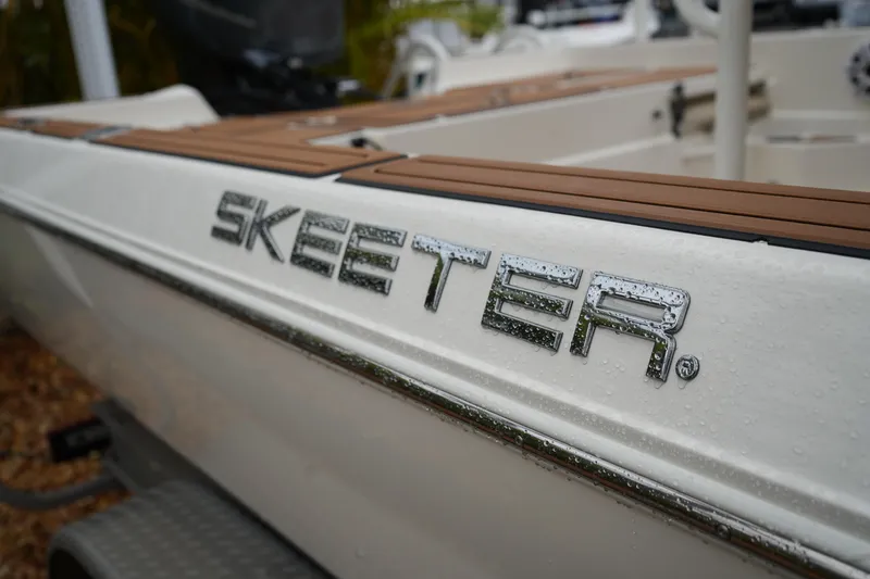 Slide: The Image of 2017 Skeeter SX230 boat with sleek design and water droplets on the surface. - 13