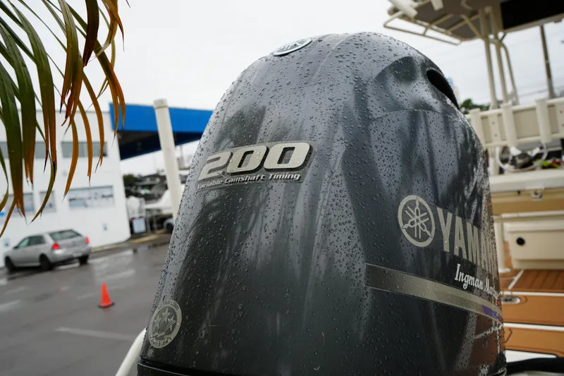 Slide: The Image of 2017 Skeeter SX230 with Yamaha 200 engine, wet with raindrops, in a marina setting. - 17