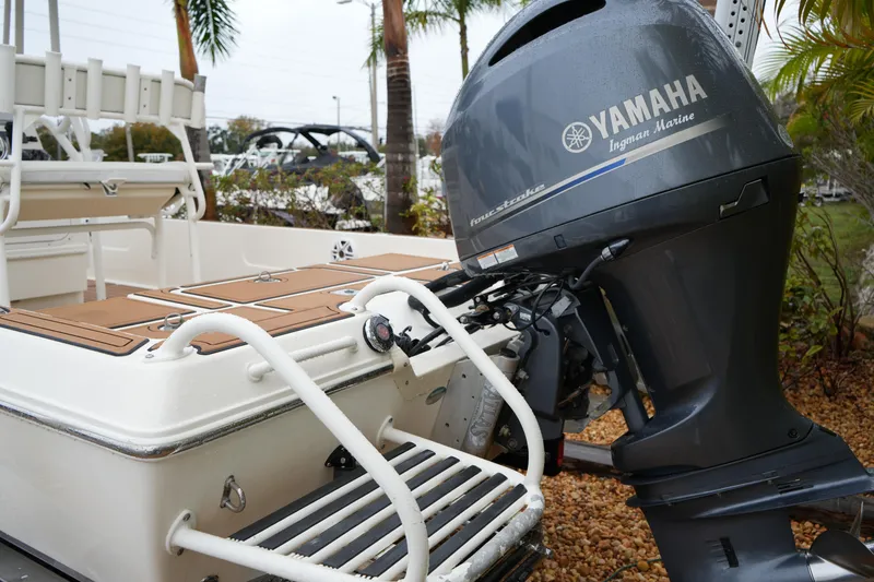 Slide: The Image of 2017 Skeeter SX230 boat with Yamaha outboard motor, docked near palm trees. - 20