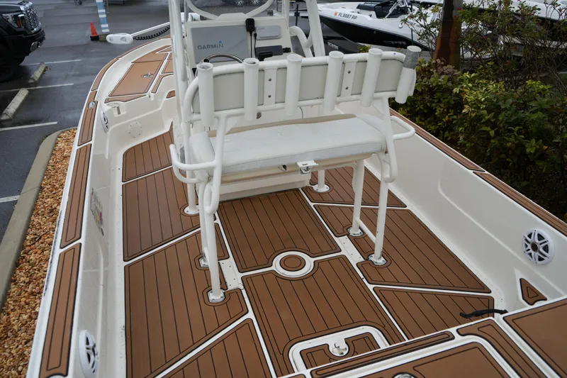 Slide: The Image of 2017 Skeeter SX230 boat interior with brown deck and white seating. - 23