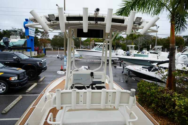 Slide: The Image of 2017 Skeeter SX230 boat in a dealership lot, surrounded by other boats and vehicles. - 24