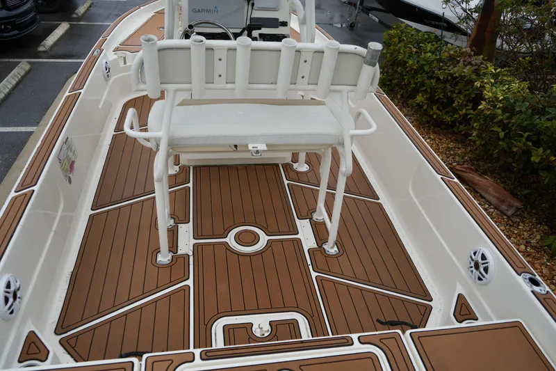 Slide: The Image of 2017 Skeeter SX230 boat interior with brown deck and white seating. - 25