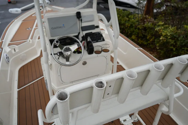Slide: The Image of 2017 Skeeter SX230 boat interior with Garmin navigation and rod holders. - 26