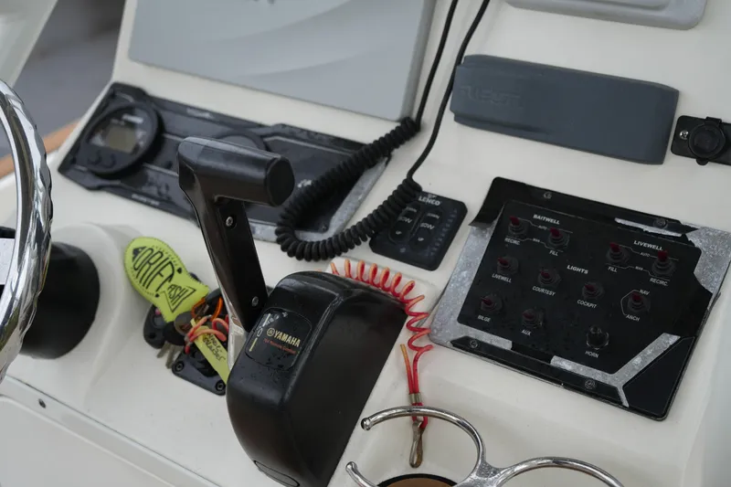 Slide: The Image of Control panel of a 2017 Skeeter SX230 boat with Yamaha throttle and switches. - 28