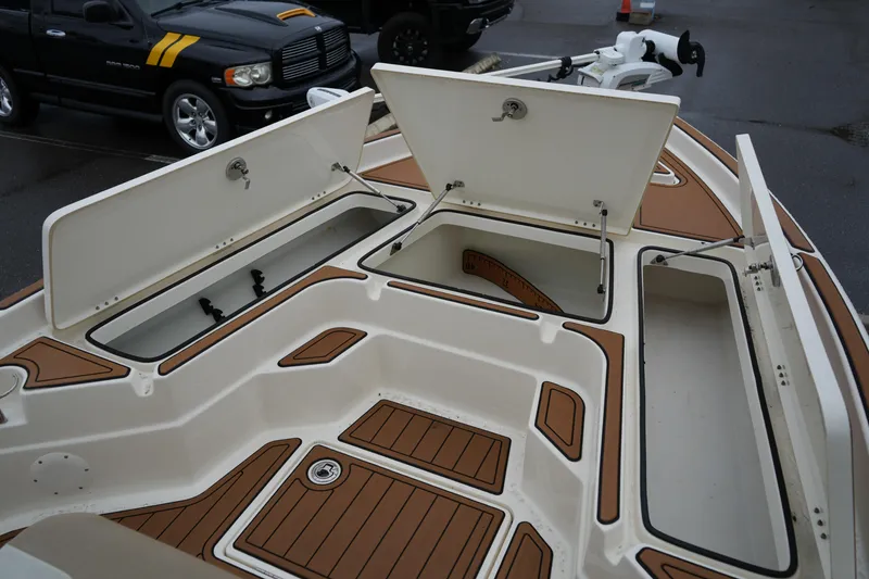 Slide: The Image of 2017 Skeeter SX230 boat deck with open storage compartments. - 31