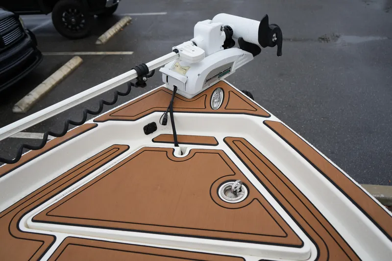 Slide: The Image of 2017 Skeeter SX230 boat deck with trolling motor and brown non-slip surface. - 32