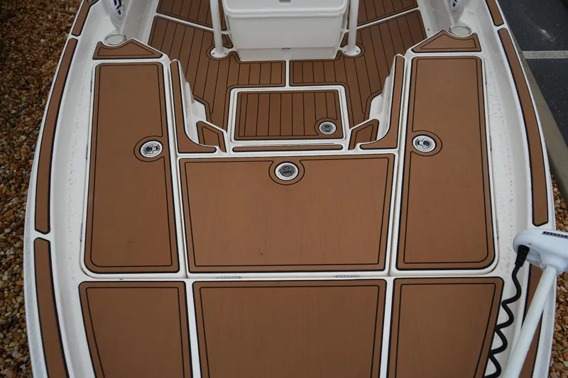Slide: The Image of 2017 Skeeter SX230 boat deck with brown non-slip surface and white trim. - 33