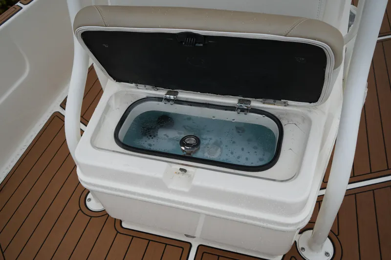 Slide: The Image of Livewell on 2017 Skeeter SX230 boat with teak-style flooring. - 37