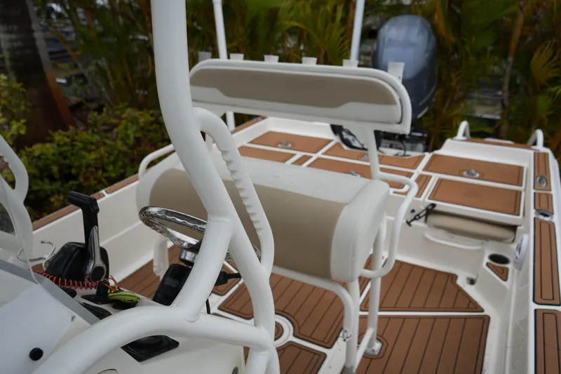 Slide: The Image of 2017 Skeeter SX230 boat interior with steering wheel and seating, featuring wood accents. - 38