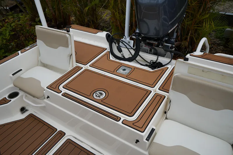 Slide: The Image of 2017 Skeeter SX230 boat deck with tan and white seating and storage compartments. - 41
