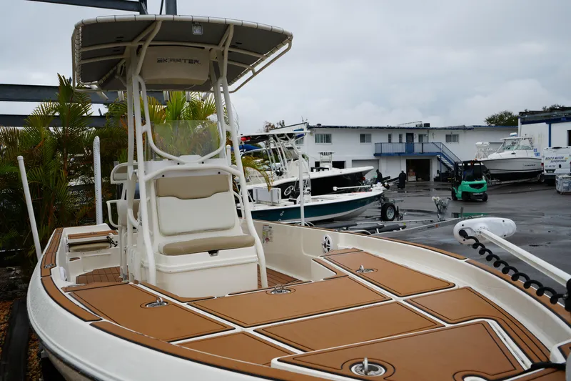 Slide: The Image of 2017 Skeeter SX230 boat in a marina, showcasing sleek design and spacious deck. - 7